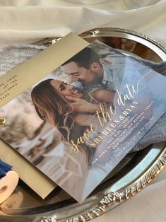 a wedding save the date card on a silver tray