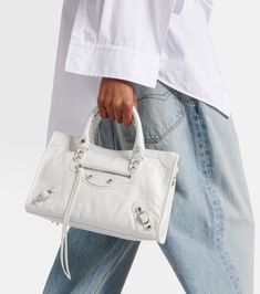 Le City Small leather shoulder bag in white - Balenciaga | Mytheresa Luxury White Shoulder Bag With Zipper, Luxury White Shoulder Bag With Zipper Closure, Luxury White Satchel With Zipper Closure, Designer White Shoulder Bag With Zipper Closure, Balenciaga First, White Balenciaga, City Bag, Balenciaga City Bag, White Trim