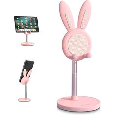 a pink bunny ear phone holder next to an iphone and a stand with a cell phone in it