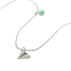 "Get the Calico Sun™ Silver Paper Airplane Emma Necklace at Michaels. com. Suspended from an adjustable silver ball chain necklace, the metal pendant is accented with a charming green pom pom for fashionable chic. This unique metal paper airplane shaped silver pendant will be a standout for anyone who wears it. Suspended from an adjustable silver ball chain necklace, the metal pendant is accented with a charming green pom pom for fashionable chic. For more high flying fun, pair with the Emma pap Playful Silver Charm Necklaces, Playful Adjustable Silver Necklace, Playful Adjustable Silver Charm Necklace, Emma Necklace, Silver Paper, Paper Airplane, Ball Chain Necklace, Paper Airplanes, Toned Paper