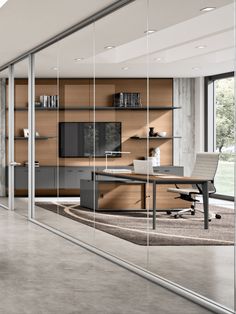 an office with glass walls and wooden cabinets