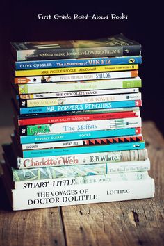 a stack of books sitting on top of a wooden table