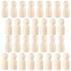 a large group of white wooden dolls standing next to each other on a white background