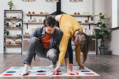 a man and woman are playing on the floor