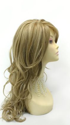 "Long heat resistant synthetic wig featuring a skin side part and loose waves that cascade down your back. Inside cap has adjustable straps for a secure fit. Color: Dark Ash Blonde with Light Blonde Highlights (14/22) Style: 23 inches, Long and Wavy Circumference: 21\" with adjustable cap (max 22\"). Materials: Synthetic Wig Fiber Bangs and length can be cut and adjusted upon request. All sales are final. Please read all store policies before purchasing." Wavy Blonde Wigs, Synthetic Wigs Blonde, Max Wigs, Wig Care Synthetic, Blonde With Light Blonde Highlights, Dark Ash Blonde, Light Blonde Highlights, Dark Ash, Side Part