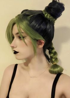 a woman with green hair wearing a black bra top and braided bun hairstyle