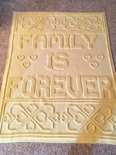 a crocheted rug on the floor with words written in different languages and numbers