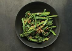 broccoli and green beans in a black bowl