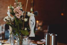 a vase filled with flowers sitting on top of a table next to other plates and silverware