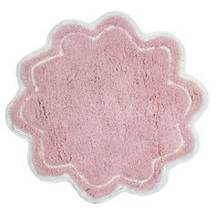 a pink rug with white trim on the bottom and an oval shape in the middle