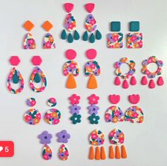 a collection of colorful earrings and earring pieces on a white surface with the number five below them