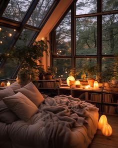 an instagram photo of a bedroom with candles on the bed and lights in the windows