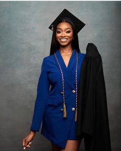 a woman in a graduation cap and gown posing for a photo with her hood up