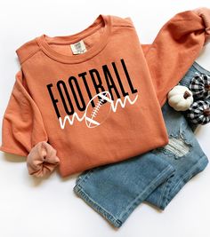 This Football Mom Crewneck Sweatshirt offers a cozy and stylish way for football moms to show off their support during games and practices. The relaxed fit and lightweight fabric make it perfect for layering or wearing on its own. Ideal for football moms looking for a comfortable and fashionable way to cheer on their athlete. Product features - 100% ring-spun cotton for durability and comfort - 1x1 ribbed cuffs and bottom hem for a well-fitted look - Shoulder and neck tape for added stability and prevent stretching - Without side seams for a clean and attractive finish - Sewn-in twill label for added detail Care instructions - Machine wash: cold (max 30C or 90F) - Do not bleach - Tumble dry: low heat - Iron, steam or dry: low heat - Do not dryclean Sports Mom Sweatshirt, Football Mom Outfits, Football Mom Outfit, Football Moms, Mom Crewneck, Football Sweater, Football Game Outfit, Football Mom Shirts, Comfort Colors Sweatshirt