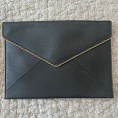 Black Rebecca Minkoff Leather Clutch - 10.5/7.5 Inches. Brand New, Never Used In Perfect Condition. I Also Have The Protective Bag To Ship It In. It Has A Gold Zipper Detail Around The Front Edges. The Inside Is Lined In A Black And White Pattern With A Button Close. 6 Individual Credit Card Slots Inside. Black And White Pattern, Black Clutch, Gold Zipper, Zipper Detail, White Patterns, Leather Clutch, Rebecca Minkoff, Card Slots, Slots