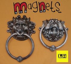 two metal door handles with lion heads on them and the words magnets above them