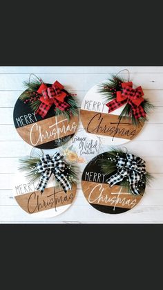 three wooden christmas signs with bows on them