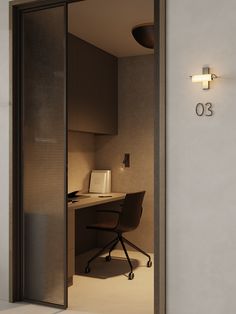 an open door leading into a room with a desk and chair on the other side