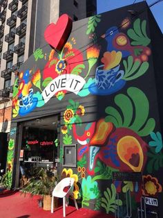 a building painted with colorful flowers and hearts