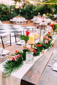 a long table with candles and flowers on it