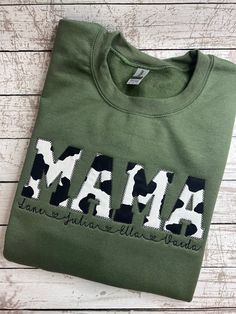 Cow Print Mama Crewneck Sweater | Applique Embroidery | Cow Print | Personalized | Crewneck Sweatshirt | Embroidery Shirt  Cow Print Fabric Appliqued to a Crewneck Sweater in the color Military Green (First Picture). Shirts are Gildan or Port & Company, depending on availability at the time. MAMA can be changed to word of your choice. Please include this in the personalization section, if not word is specified, you will receive MAMA. Pick your shirt color and your thread color. See charts in pic Cow Print Mama Shirt, Cow Print Embroidery, Cow Sweatshirts, Sweater Applique, Taylor Embroidery, Cow Embroidery, Cow Print Fabric, Mommy Daughter Outfits