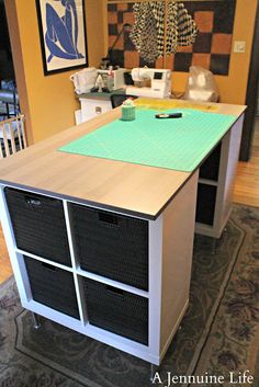 a kitchen island with baskets on it in front of a counter top and sewing machine