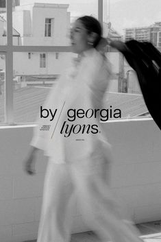 black and white photograph of a woman walking in front of a window with the words by georgia lynns on it