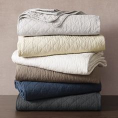 four blankets stacked on top of each other