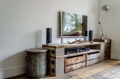 a flat screen tv sitting on top of a wooden entertainment center in a living room