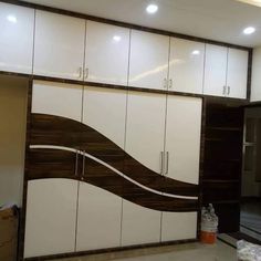 a room with white cabinets and brown lines on the wall