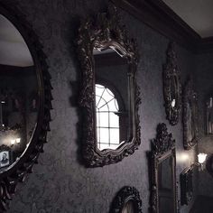 there are many mirrors on the wall in this room