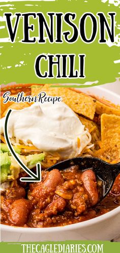 a bowl filled with chili, tortilla chips and sour cream on top of it