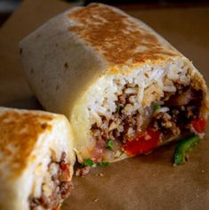 a burrito cut in half sitting on top of a table