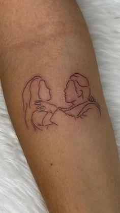 a couple holding hands tattoo on the arm