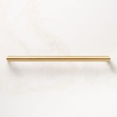 a gold colored handle on a white wall