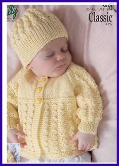 a baby wearing a yellow knitted sweater and hat sleeping on top of a bed