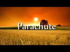 the words parachute are in front of a sunset over a wheat field with trees on it