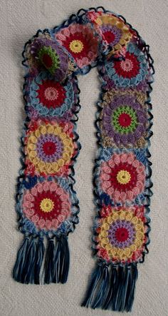 a multicolored crocheted scarf with fringes