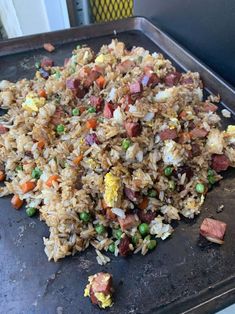 a pan filled with rice and vegetables on top of a table