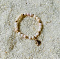 "THE perfect baby shower, new born baby gift. Conch Sea Shell beads on a strong elastic band with 14k gold filled beads and a 14k gold filled sea shell charm. 100% Ocean proof & perfect for everyday use without the need to be taken off. Floridian Ocean Jewelry ™ \"For Mermaid Babies\"" Gold Stackable Stretch Bracelet For The Beach, Gold Shell Beaded Bracelets As Gift, Gold Spiritual Stretch Bracelet For Beach, Coral Bracelet, Baby Mermaid, Perfect Baby Shower, Ocean Jewelry, Natural Coral, Shell Bracelet