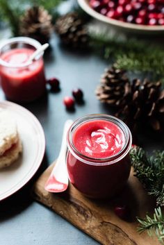 a jar of cranberry sauce next to a plate of food