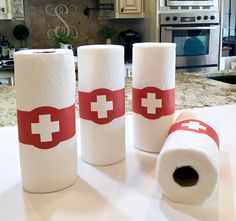 three rolls of toilet paper sitting on top of a kitchen counter next to each other