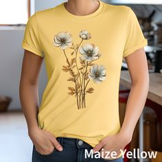 Inspired by the beauty of wildflowers, this charming tee showcases a delightful spring bouquet, bringing a touch of nature's enchantment to your wardrobe. Crafted with love and attention to detail, our flower T-shirt combines comfort and style effortlessly. Made from soft, breathable fabric, this relaxed-fit tee is perfect for everyday wear or for adding a touch of boho chic to any outfit. Whether you pair it with jeans or a flowy skirt, this T-shirt is sure to make you radiate natural beauty wherever you go. Embrace the essence of the flowers and let this tee be a sweet reminder of blooming possibilities. Product information: These t-shirts have-ribbed knit collars to bolster shaping. The shoulders have taping for better fit over time. Dual side seams hold the garment's shape for longer. Spring Bouquet, Granola Girl, Flowy Skirt, Nature Inspired, San Jose, Breathable Fabric, Boho Chic, Nature Inspiration, Ribbed Knit