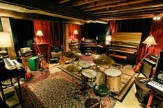 a living room filled with lots of furniture and musical instruments