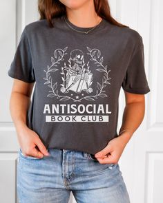 Looking for the perfect gift for a book-loving friend or family member? Look no further than this Comfort Colors T-shirt for the Anti-Social Book Club. With its stylish design and comfortable fit, this shirt is sure to be a hit with any bookworm or booktrovert. Bookish Cotton T-shirt With Letter Print, Bookish Crew Neck T-shirt With Letter Print, Screen Print Short Sleeve Tops, Literary Style Short Sleeve Screen Print Tops, Bookish T-shirt With Letter Print And Crew Neck, Literary Crew Neck T-shirt With Screen Print, Black Bookish T-shirt With Screen Print, Screen Print Crew Neck T-shirt, Literary Graphic Print Crew Neck T-shirt