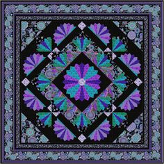 a purple, blue and black quilt with an intricate design on the center in the middle