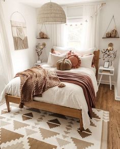 a bed room with a neatly made bed next to a window and rugs on the floor