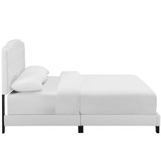 a bed with white linens and pillows on top of it, against a white background