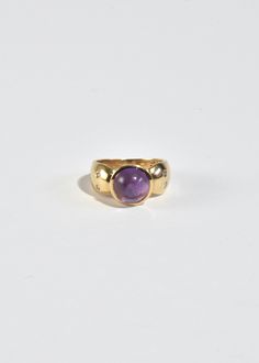 Stunning vintage gold ring with round amethyst cabochon and petite sapphire detail. Stamped 10k. Material: 10k gold, amethyst, sapphire. We recommend storing in a dry place and periodic polishing with a cloth. Vintage Round Cabochon Gemstones, Timeless Round Cabochon Sapphire Ring, Purple Amethyst Hallmarked Signet Ring, Amethyst Gemstone Signet Ring, 14k Gold Domed Signet Ring With Gemstone, Yellow Gold Amethyst Cabochon Ring, Antique Gold Amethyst Ring With Center Stone, Vintage Yellow Gold Amethyst Ring, Gold Amethyst Ring With Cabochon Cut