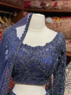 Midnight blue craftsmanship with fine details of beads, stone, thread and cutdana nestled on silk fabric in floral embroidery bloom this lehenga. Includes a ready long sleeves blouse paired with beautiful net dupatta. If you are planning to ace the grace of your D-day dress, then this Midnight Blue is the best choice. Fabric: Net Size: 38/M Occasion: Wedding Ceremony or Reception WASH CARE INSTRUCTIONS - Please Dry clean only when it is applicable. Slight color variation is possible due to digit Organza Lehenga With Sheer Dupatta, Organza Lehenga With Sheer Dupatta And Long Sleeves, Long Sleeve Lehenga With Sheer Dupatta In Organza, Party Wear Choli With Intricate Embroidery And Long Sleeves, Party Wear Long Sleeve Choli With Intricate Embroidery, Long Sleeve Choli With Intricate Embroidery For Party, Semi-stitched Long Sleeve Organza Choli, Dola Silk Lehenga With Long Sleeves For Wedding, Raw Silk Lehenga With Long Sleeves For Reception